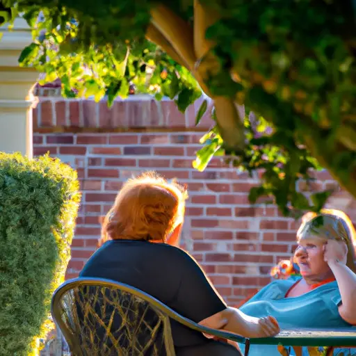 An image showcasing two mature Christians engaged in deep conversation, seated on a cozy patio with warm sunlight filtering through trees, fostering a sense of connection and companionship for Christian singles over 50