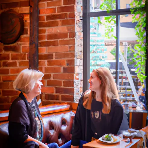 An image showcasing two individuals engaged in a lively conversation at a cozy café, their faces radiating genuine smiles