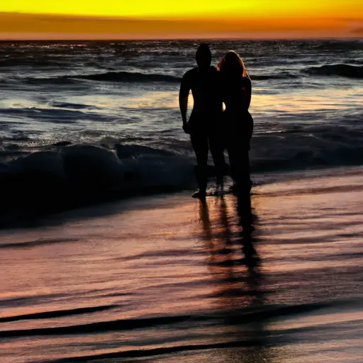 An image capturing a couple standing on a serene beach at sunset, their silhouettes intertwined as they embrace, with the golden hues of the sky reflecting on the shimmering ocean waves behind them