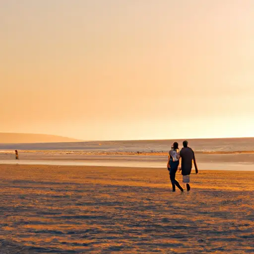 An image of two lovers strolling hand in hand along a serene beach at sunset