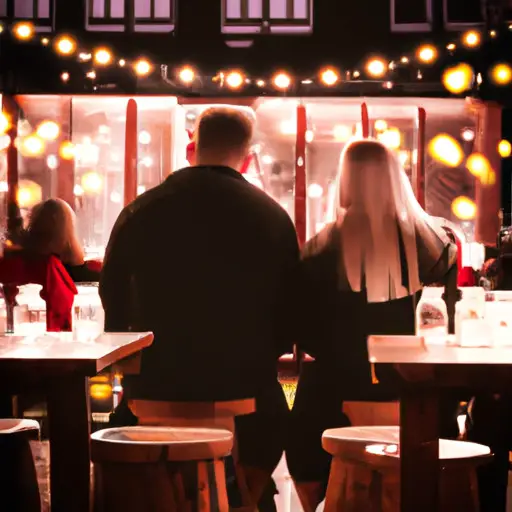 An image showcasing a couple sitting across each other at a candlelit table in a charming café, surrounded by the warm glow of hanging fairy lights, capturing the anticipation and connection of a first date