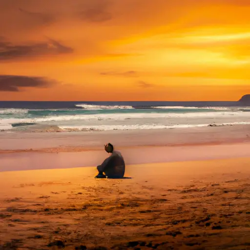 An image showcasing a person sitting alone on a peaceful beach, gazing at the sunset with a pensive expression