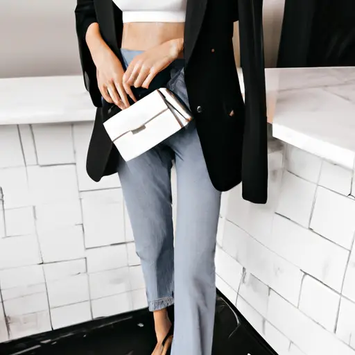 An image showcasing a woman wearing a tailored black blazer, white silk camisole, distressed high-waisted jeans, and black pointed-toe heels while carrying a small designer clutch, exuding an effortlessly chic vibe perfect for a nice dinner