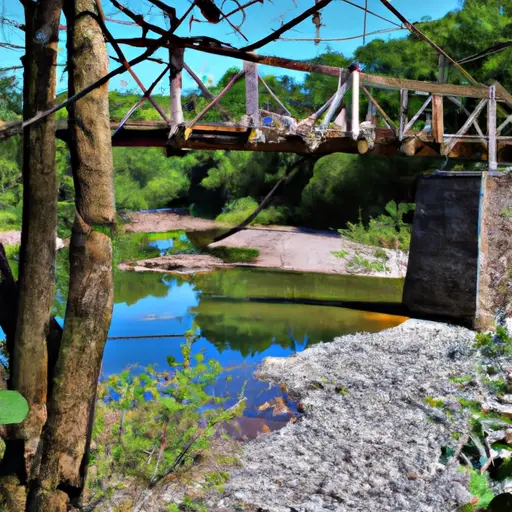 Depict an image of a weathered wooden bridge suspended above a tranquil river, with one end broken and disconnected