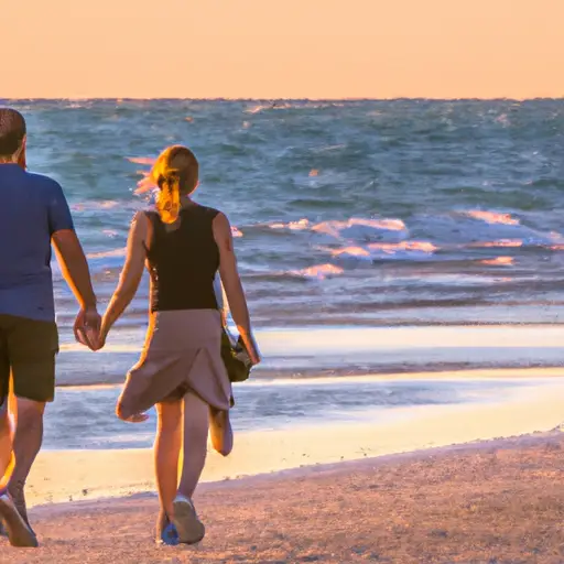 An image capturing two lovers holding hands, walking along a serene beach at sunset